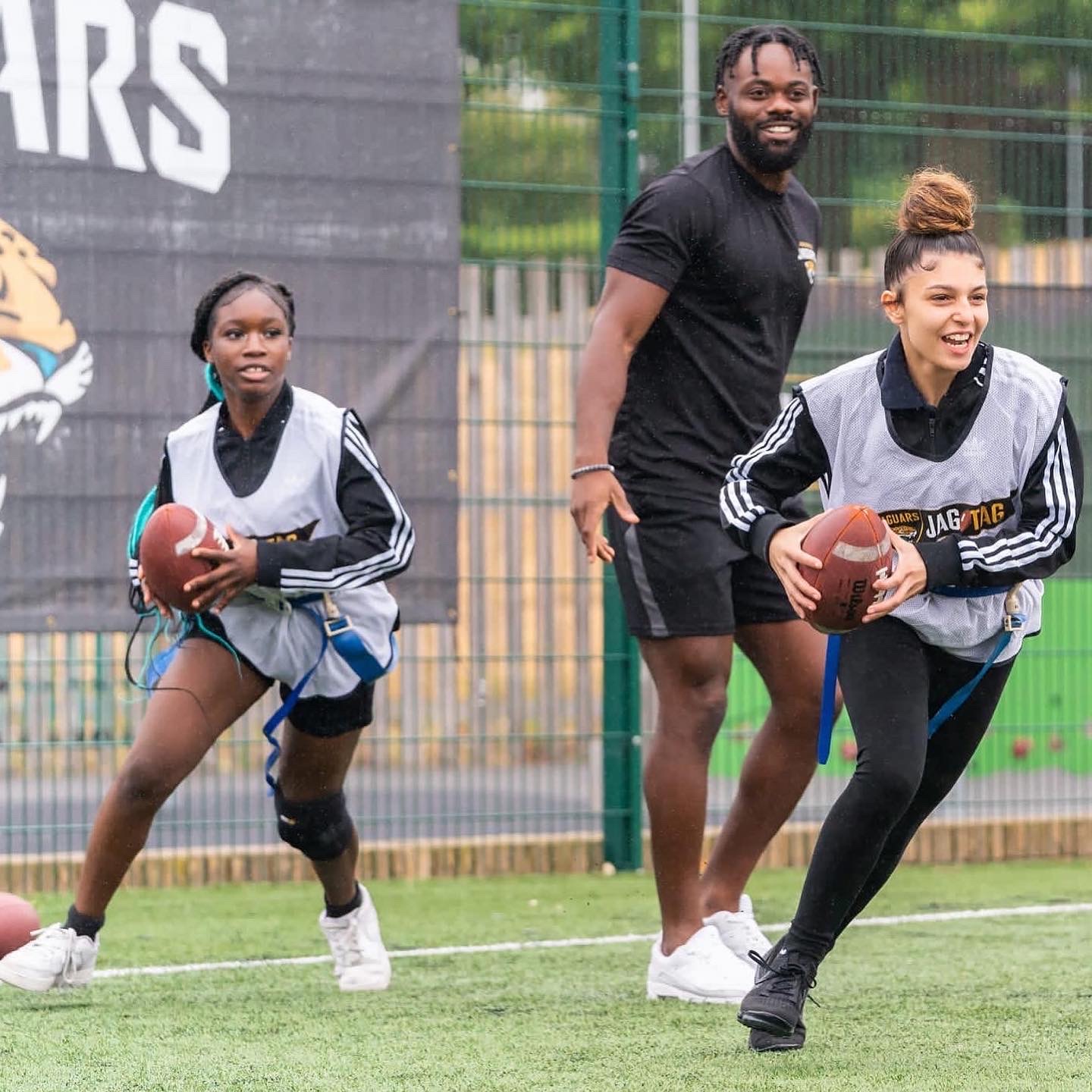 Ayo Oyelola coaching young players during a Jag Tag flag football session