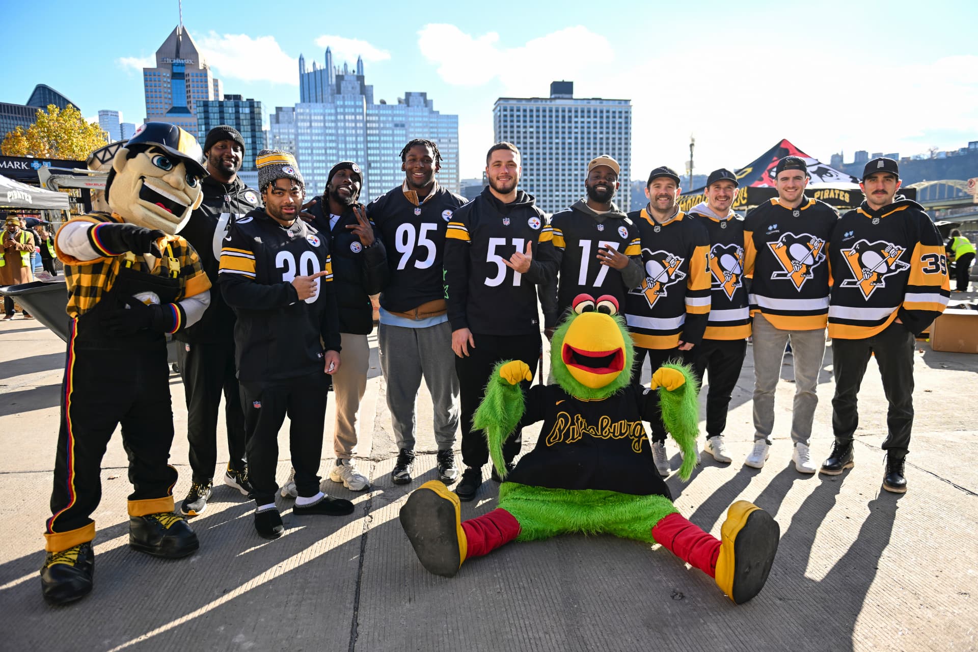 Ayo Oyelola with Steelers and Penguins players at a Pittsburgh community event
