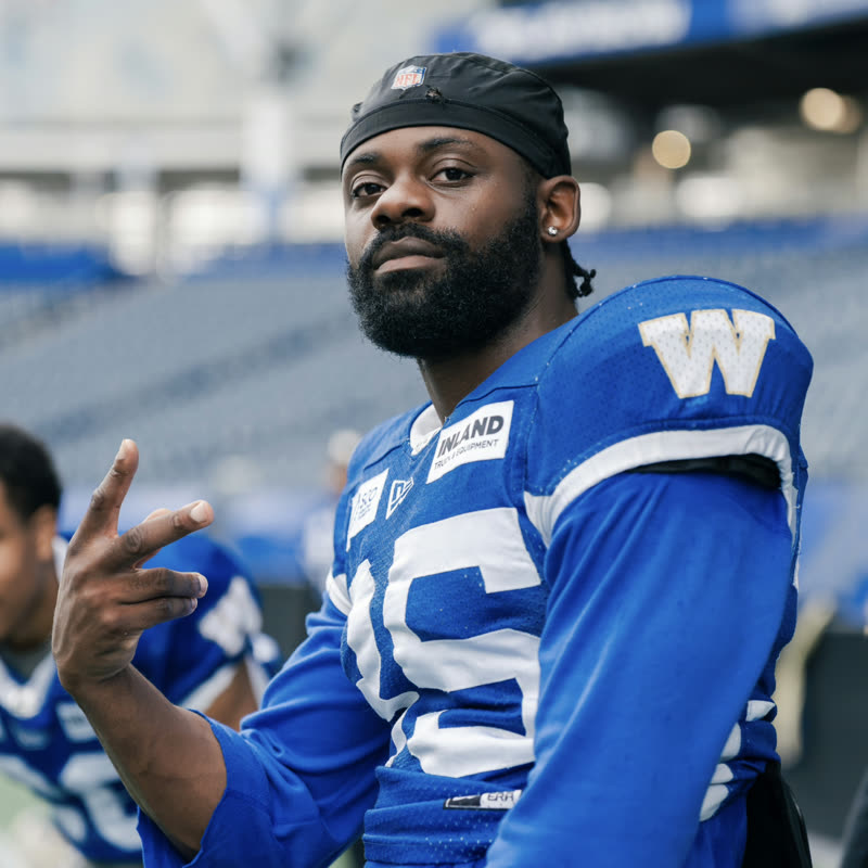Ayo Oyelola in Winnipeg Blue Bombers kit, his Substack profile photograph